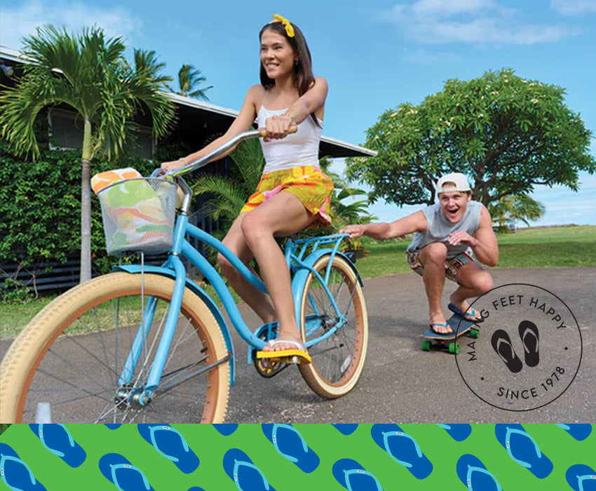 Girl and guy playing on a bike and skateboard wearing Locals slippahs