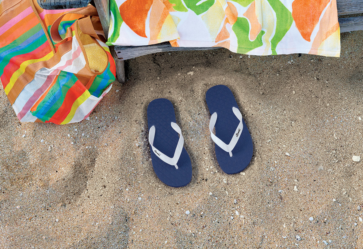 Red Locals slippahs on the beach