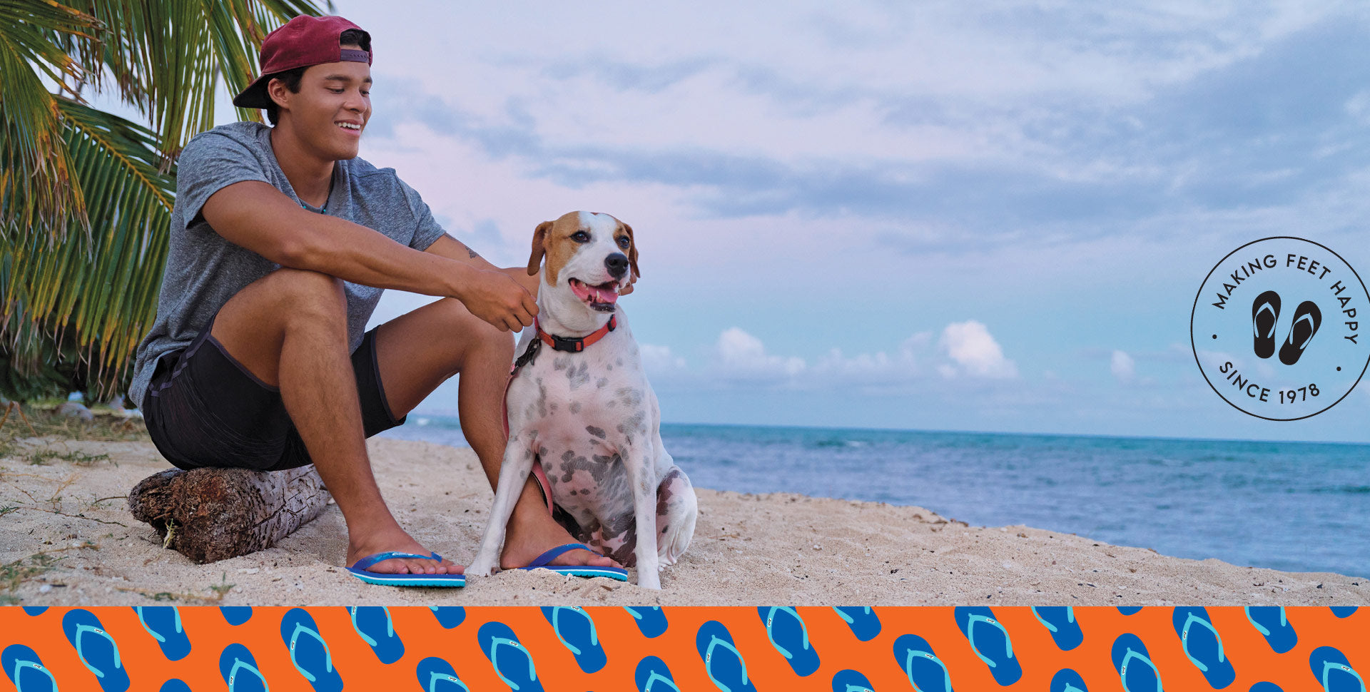 Guy and dog sitting on beach wearing Locals slippahs