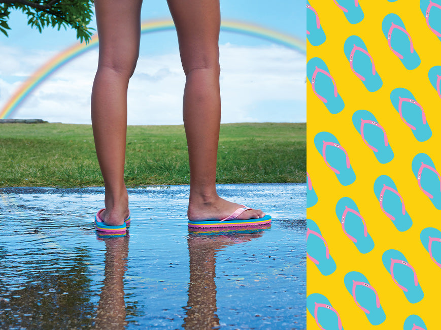 Closeup of child wearing Locals slippahs with a rainbow in the background
