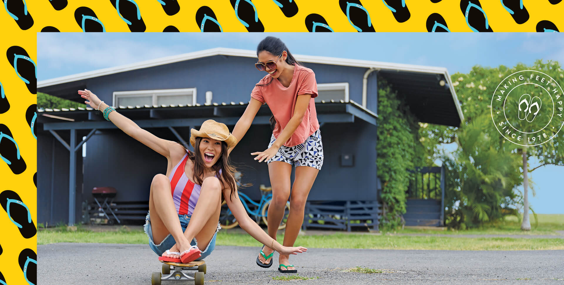 Two women playing on a skateboard wearing Locals slippahs